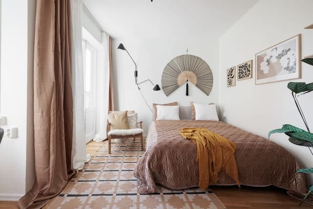 Interior of a Hornstull studio in Södermalm with modern kitchen, double bed and balcony view
