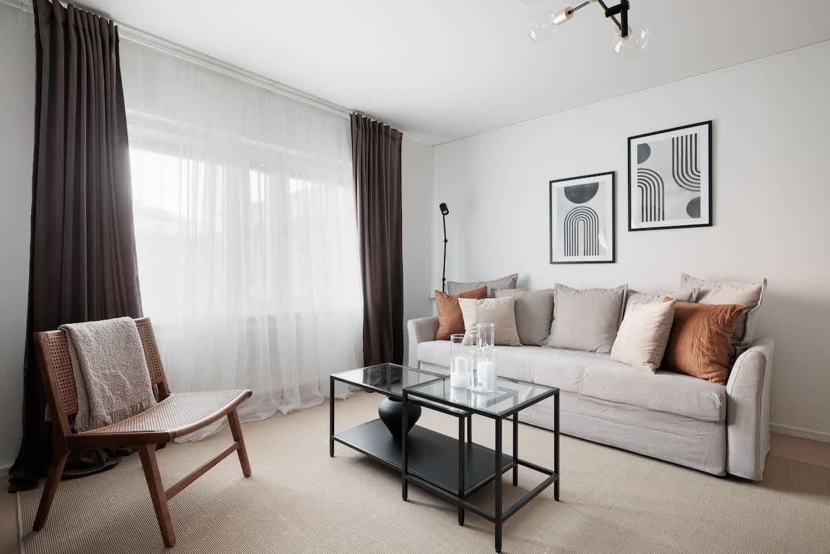 Interior view of a SoFo, Stockholm apartment featuring a sofa bed, bedroom drawers and workspace